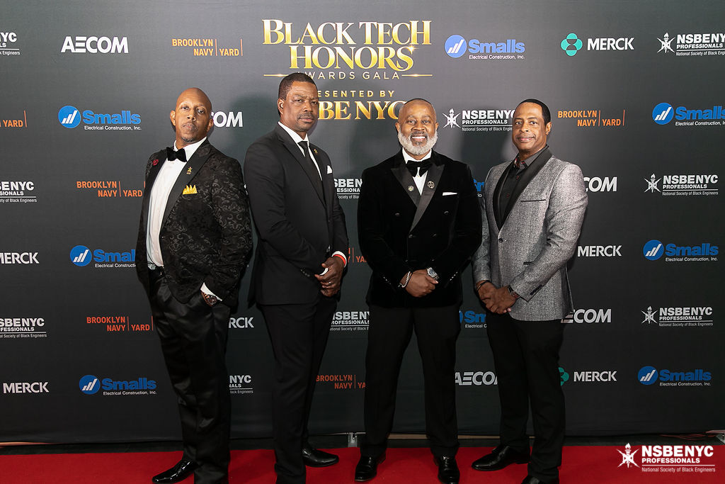 Four NSBE NYC leaders on the Black Tech Honors red carpet at the sponsor backdrop