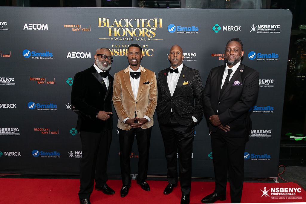 Four NSBE NYC leaders together at the Black Tech Honors sponsor backdrop