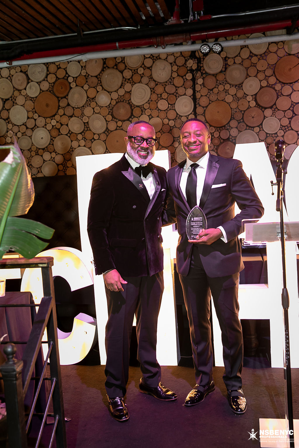 Two NSBE NYC leaders with an award on the Black Tech Honors gala stage